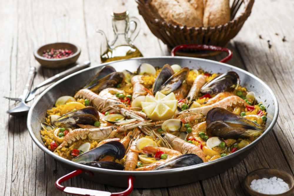 Closeup of paella with seafood on a wooden table