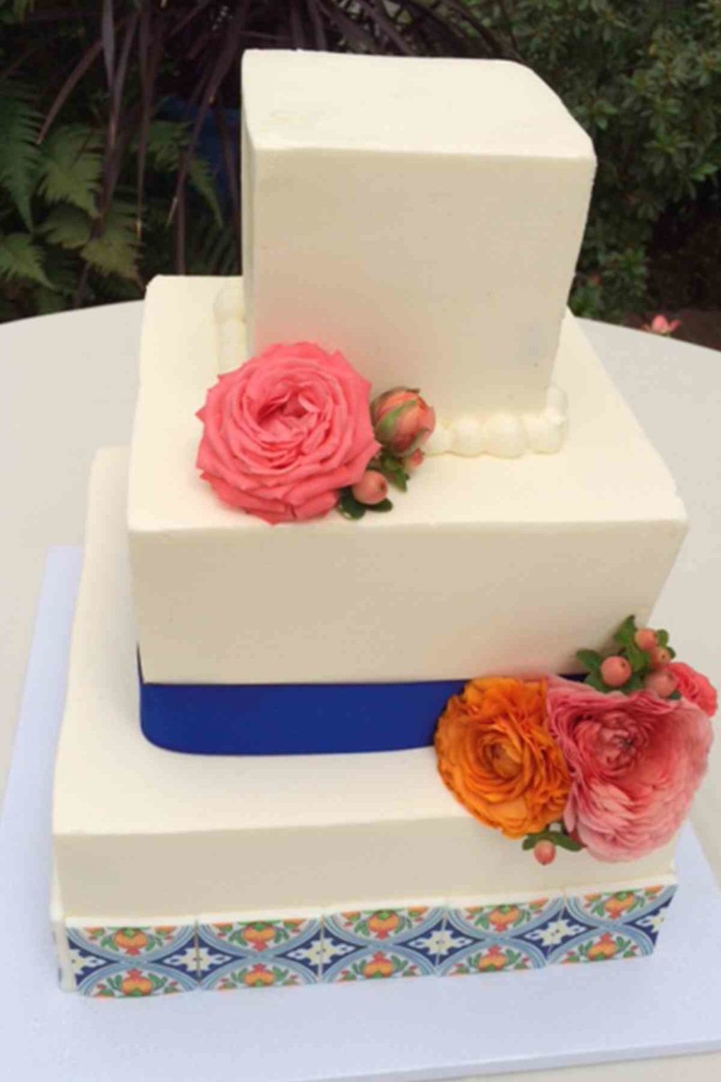 3 tier butter cream wedding cake trimmed with royal blue ribbon