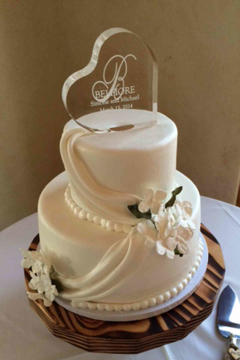 Smooth white fondant finish adorned with elegant fondant drapes and clusters of sugar hydrangeas