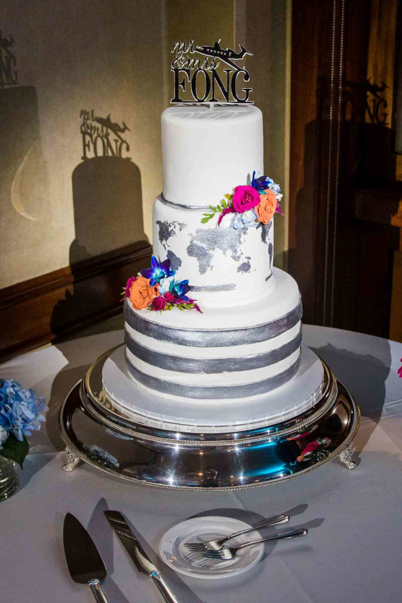 Traditional white fondant embellished with metallic silver stripes and world map